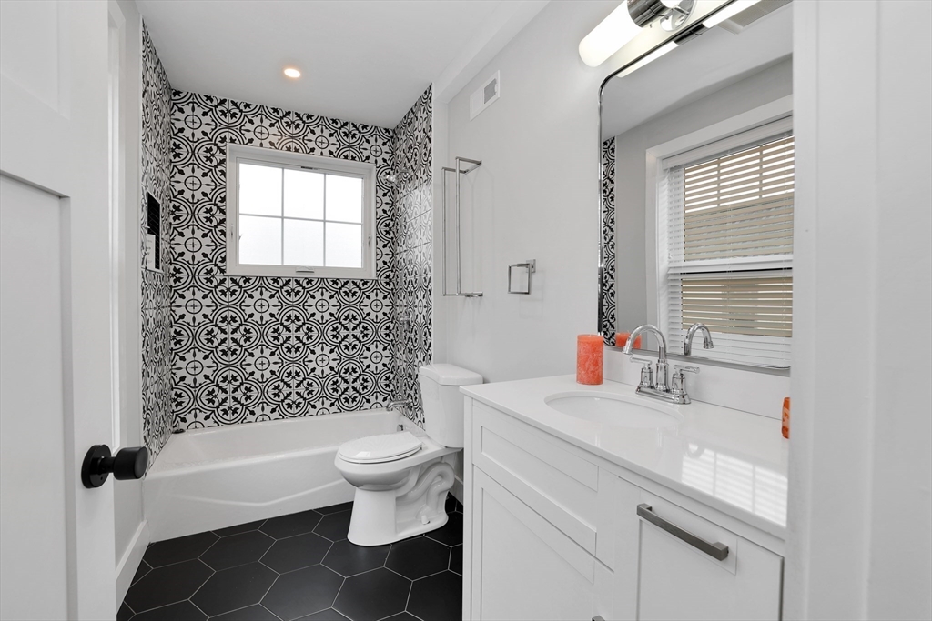 34 Temple Street Boston, MA 02126 - Photo 13 of 38 a bathroom with a sink toilet vanity and shower