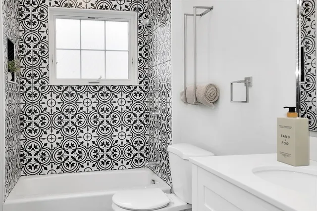 a bathroom with a sink a toilet and a tub