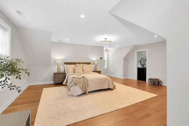 a bedroom with a large bed and a flat screen tv