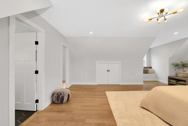 a bedroom with a bed and a chandelier