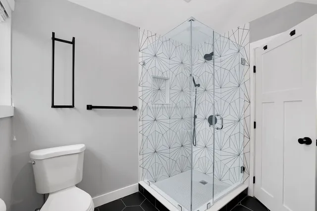a bathroom with a toilet and shower