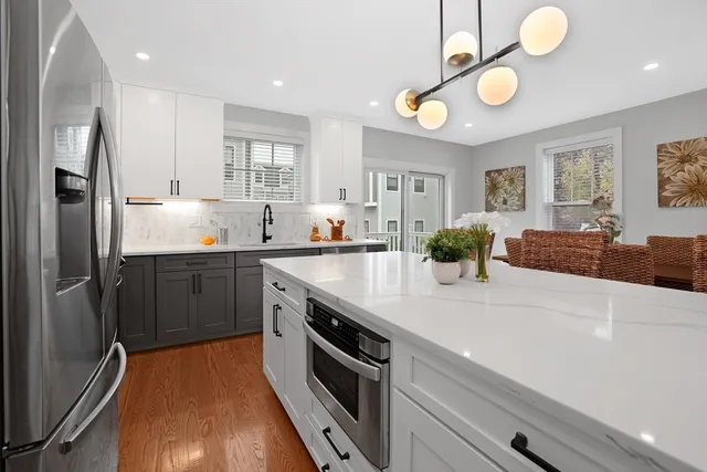 a kitchen with stainless steel appliances a sink stove and refrigerator