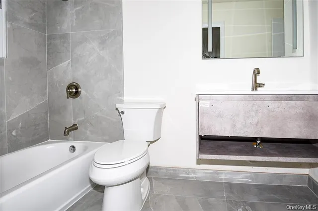 a bathroom with a toilet a sink and bathtub