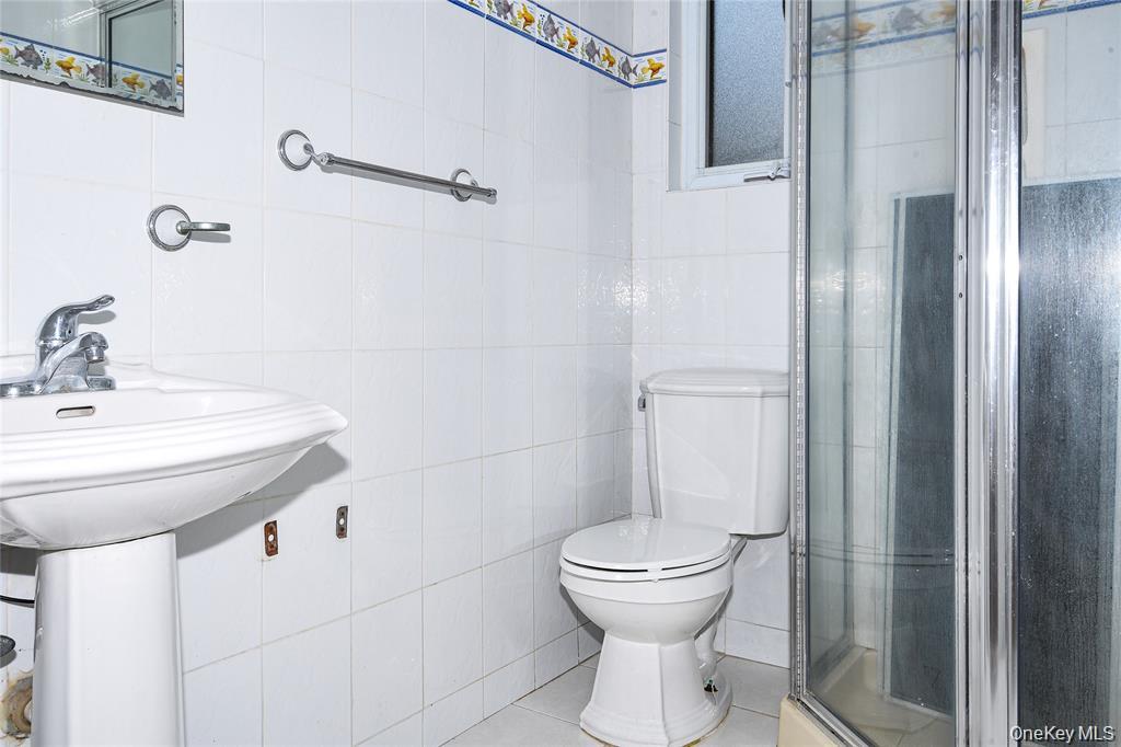 65 Bluebird Lane Plainview, NY 11803 - Photo 16 of 28 a bathroom with a sink toilet and shower