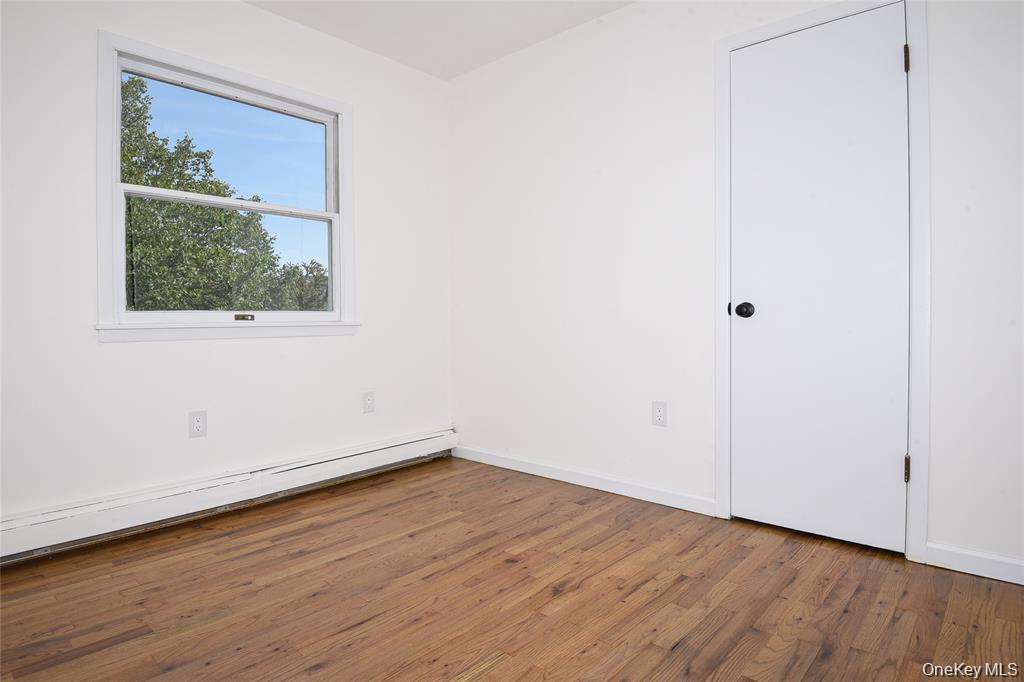 65 Bluebird Lane Plainview, NY 11803 - Photo 20 of 28 a view of a small space with wooden floor and a window
