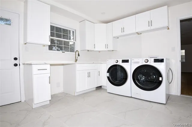 a utility room with sink dryer and washer