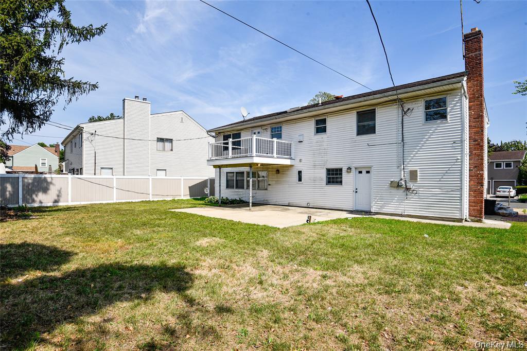 65 Bluebird Lane Plainview, NY 11803 - Photo 27 of 28 a view of a house with a backyard