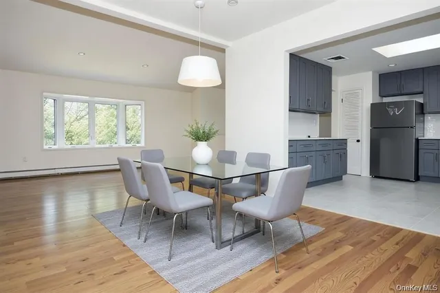 a dining room with furniture and wooden floor
