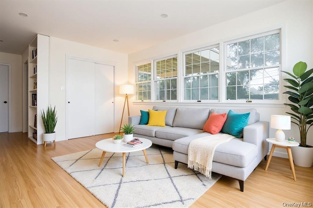 65 Bluebird Lane Plainview, NY 11803 - Photo 7 of 28 a living room with furniture and wooden floor