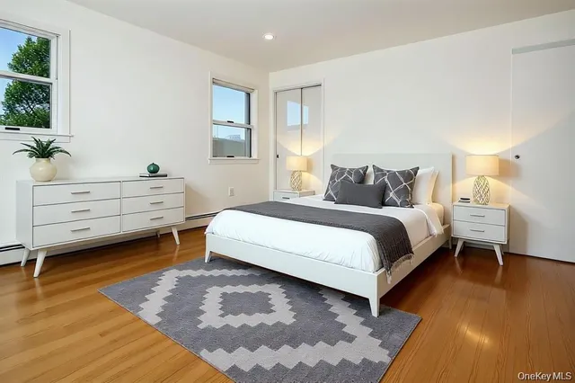 a bedroom with a bed and a potted plant