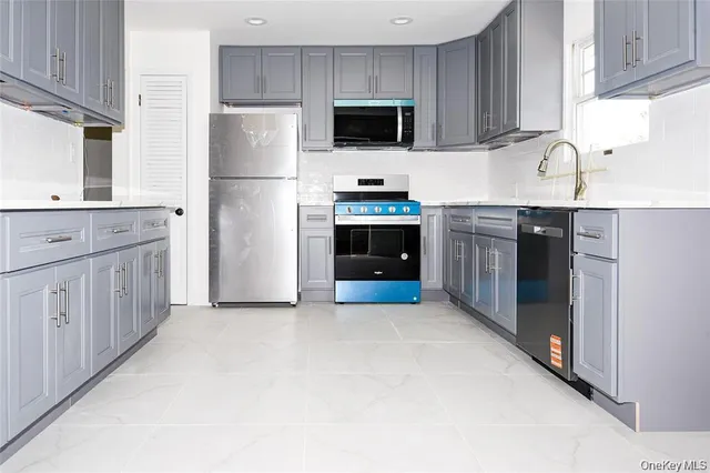 a kitchen with stainless steel appliances granite countertop a refrigerator stove a sink and dishwasher