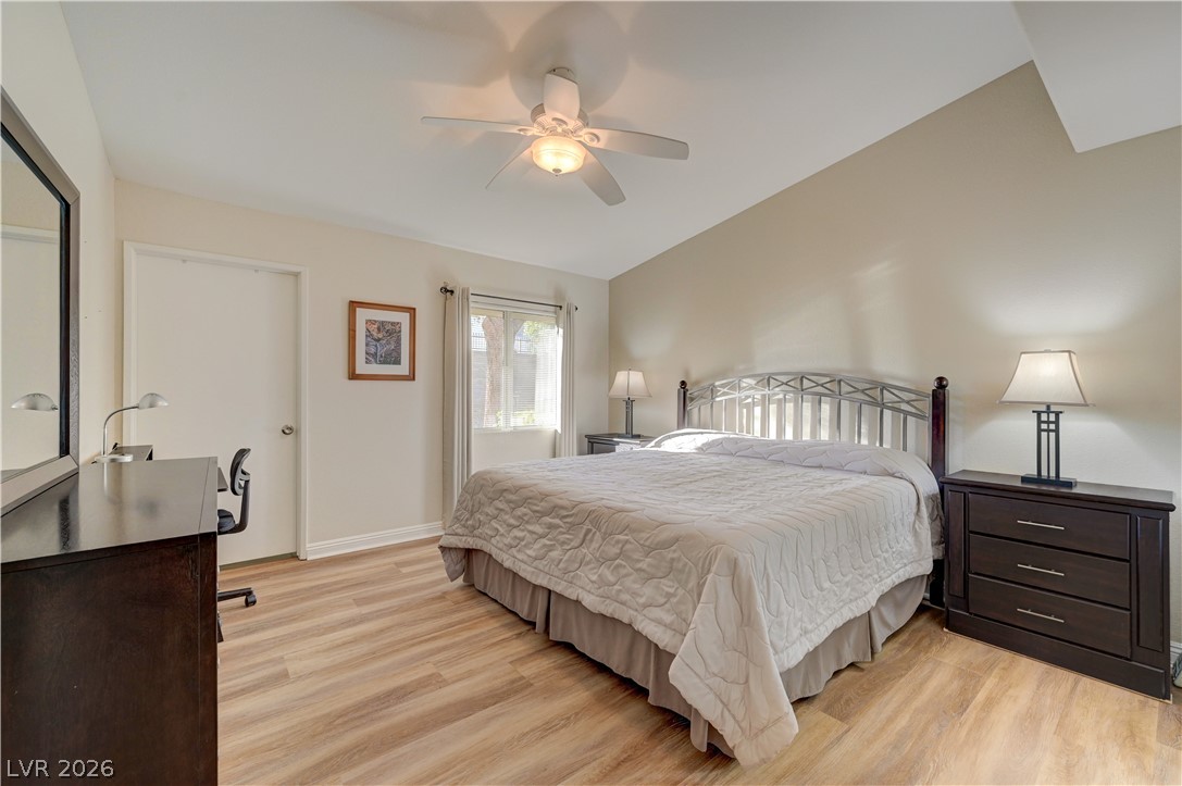 7885 West Flamingo Road, Unit 1071 Las Vegas, NV 89147 - Photo 13 of 28 Well-lit sleeping quarters with bright wood-look flooring, offering comfort and practicality.