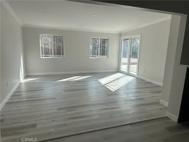 a view of wooden floor and windows in a room