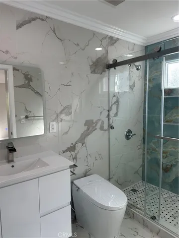 a bathroom with a sink toilet and shower