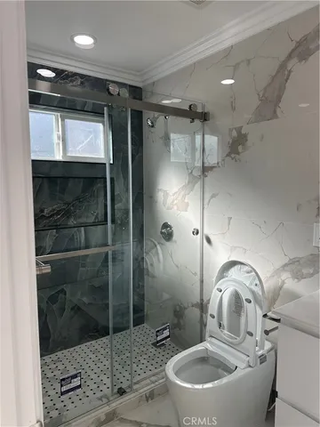 a bathroom with a toilet and a shower
