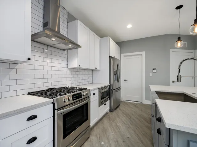 a kitchen with a sink a counter space cabinets and appliances