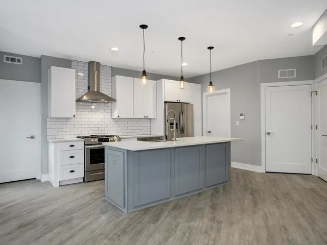 a view of a room with wooden floor