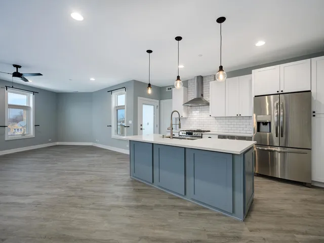 a view of a kitchen with a sink and wooden floor