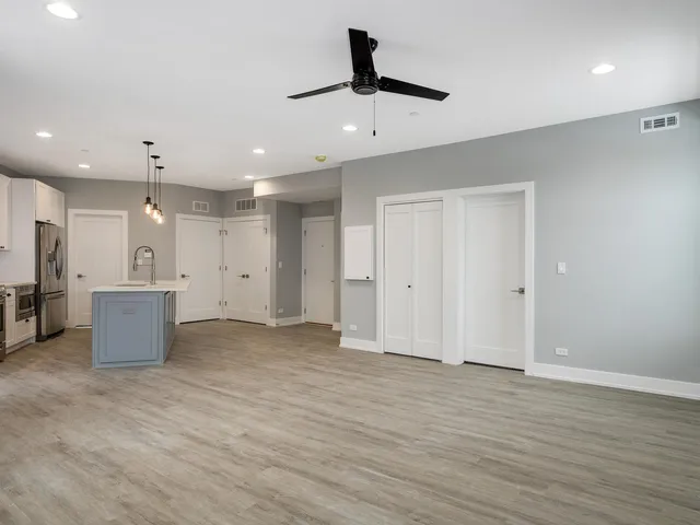 a kitchen with stainless steel appliances granite countertop a sink a stove and a refrigerator