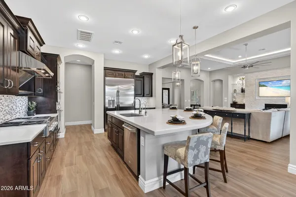 a bedroom with a large bed couch and a large window