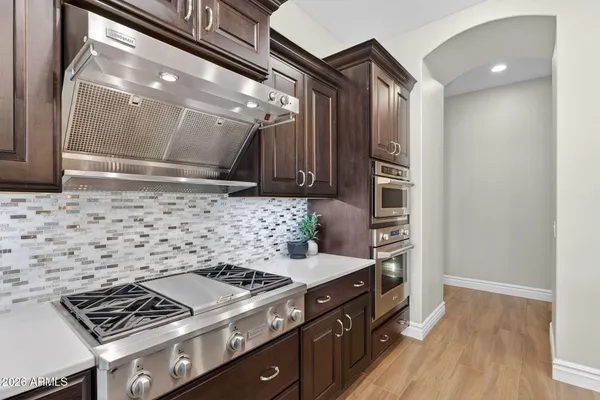 a large bed sitting in a bedroom next to a window with lamp