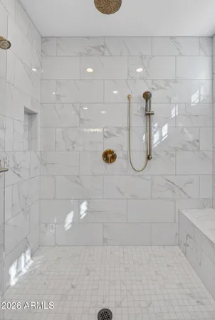 an empty room with windows and ceiling fan