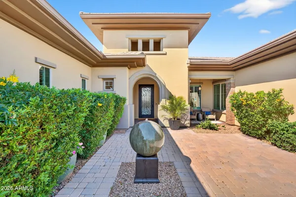 a living room with furniture a chandelier and a large window