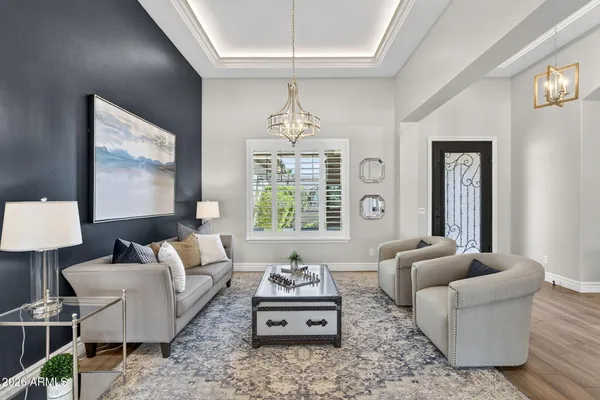 a living room with furniture or couch and a chandelier