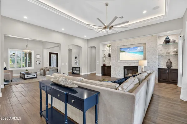 a kitchen with stainless steel appliances a sink a stove a refrigerator cabinets and chairs