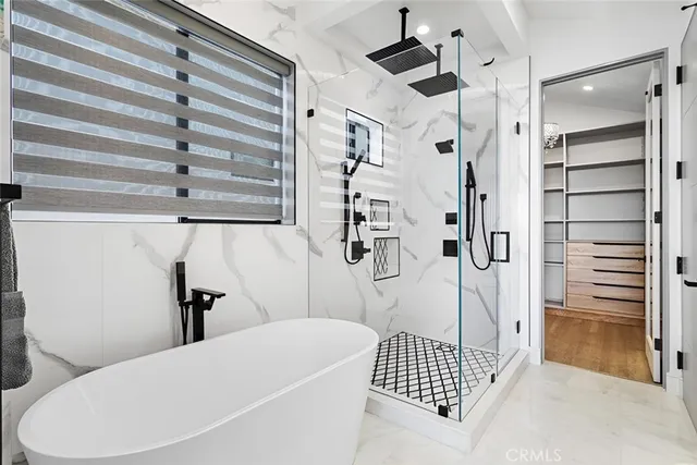 a bathroom with a bathtub and a shower