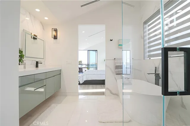 a bathroom with a tub sink and mirror