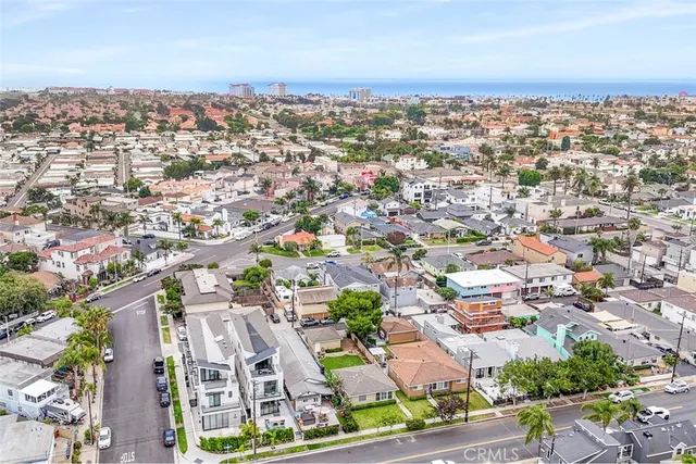 an aerial view of residential houses with city view
