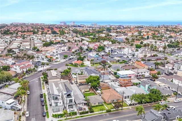 an aerial view of residential houses with city view