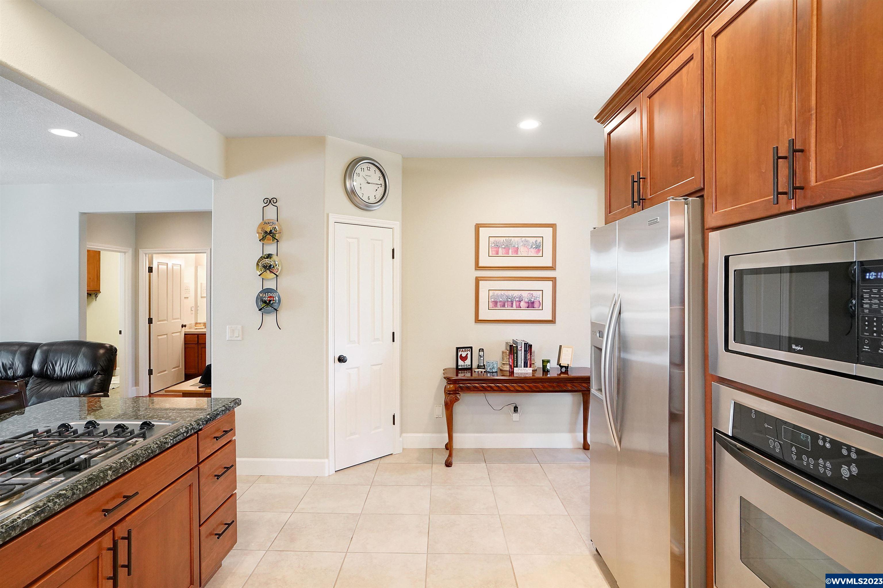 306 Northwest Reed Lane Dallas, OR 97338 - Photo 16 of 42 a kitchen with stainless steel appliances granite countertop a stove and a refrigerator