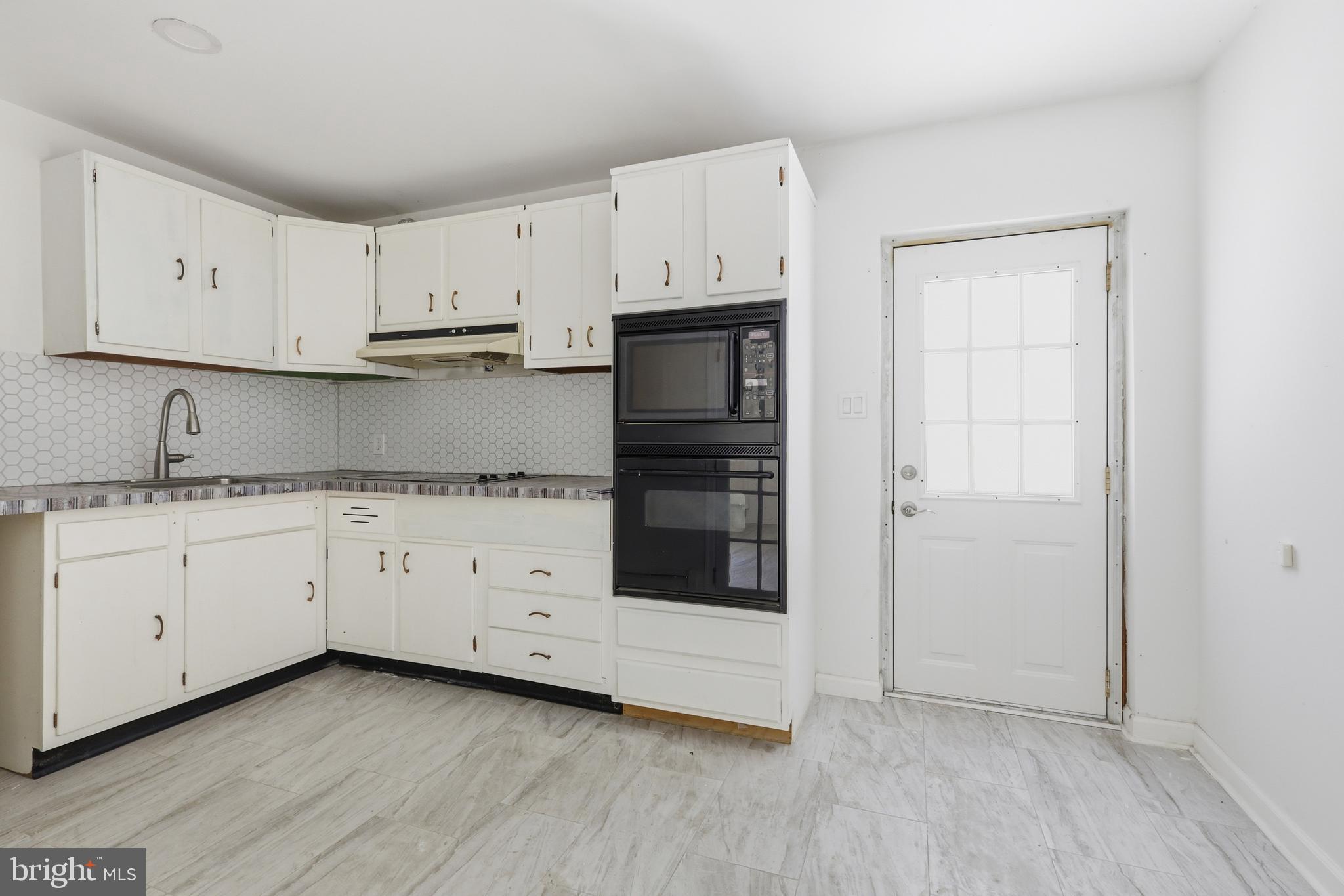 1116 Hagues Mill Road Ambler, PA 19002 - Photo 25 of 35 Lower level kitchenette w/door to driveway