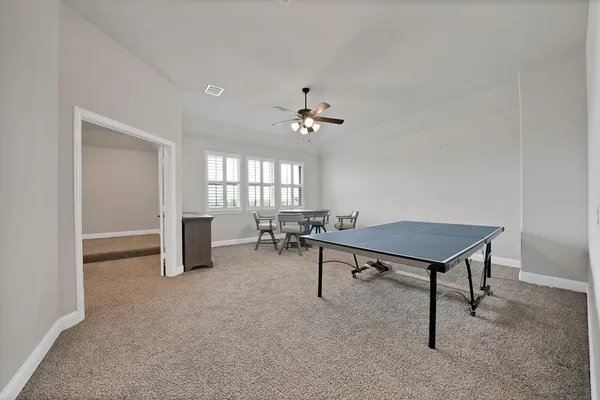 a living room with furniture a window and a table