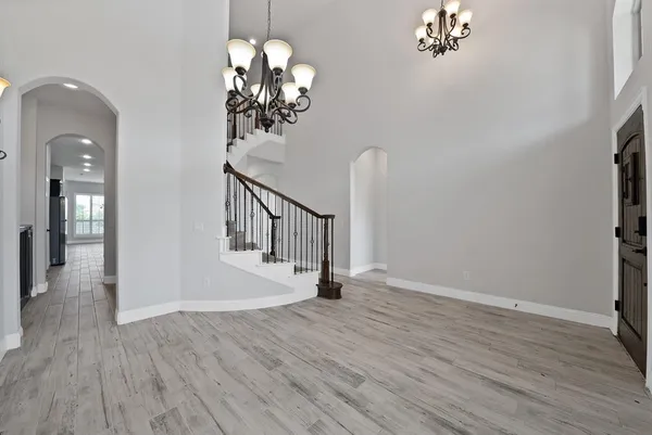 a view of a chandelier in a room with wooden floor