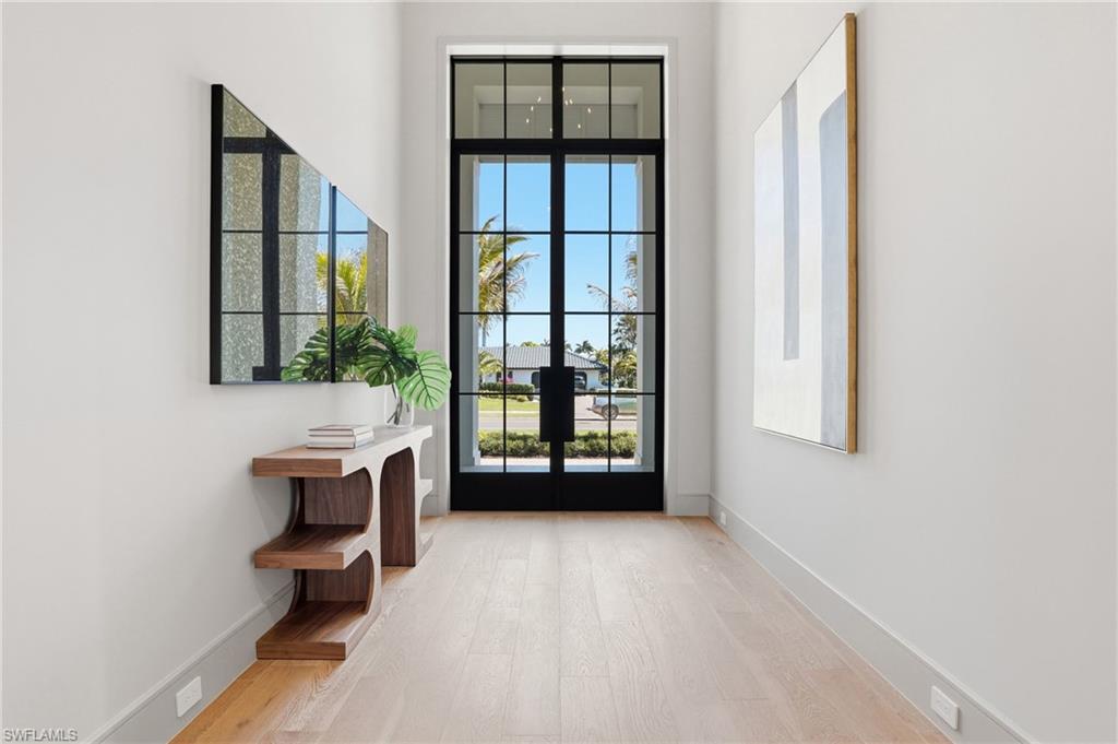 4851 Crayton Road Naples, FL 34103 - Photo 4 of 33 a view of an empty room with glass door and balcony