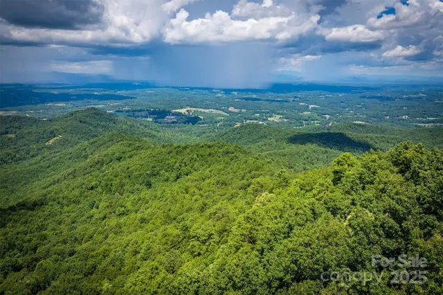 a view of a house with pool and a yard