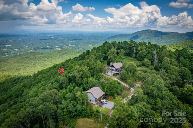 a view of a pathway both side of grassy field with shrub