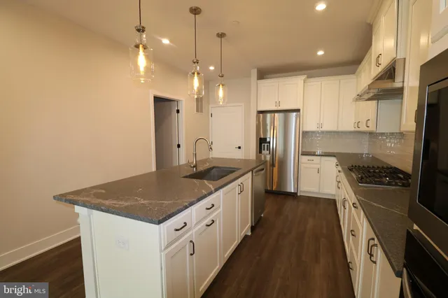 a kitchen with a sink stove and refrigerator