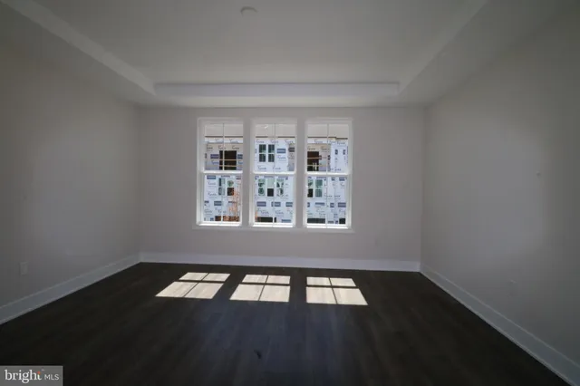 a view of a livingroom with wooden floor and a window