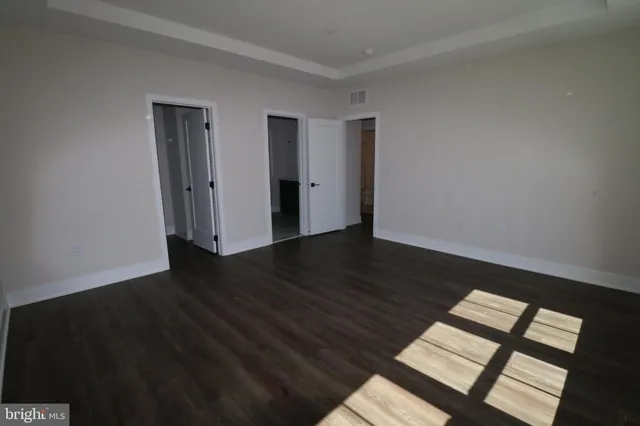 a view of wooden floor and windows in a room