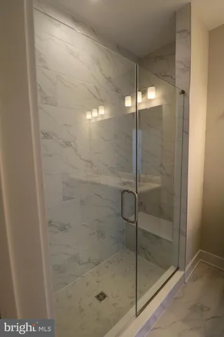 a bathroom with a glass shower door
