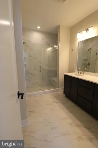 a bathroom with a double vanity sink toilet and shower