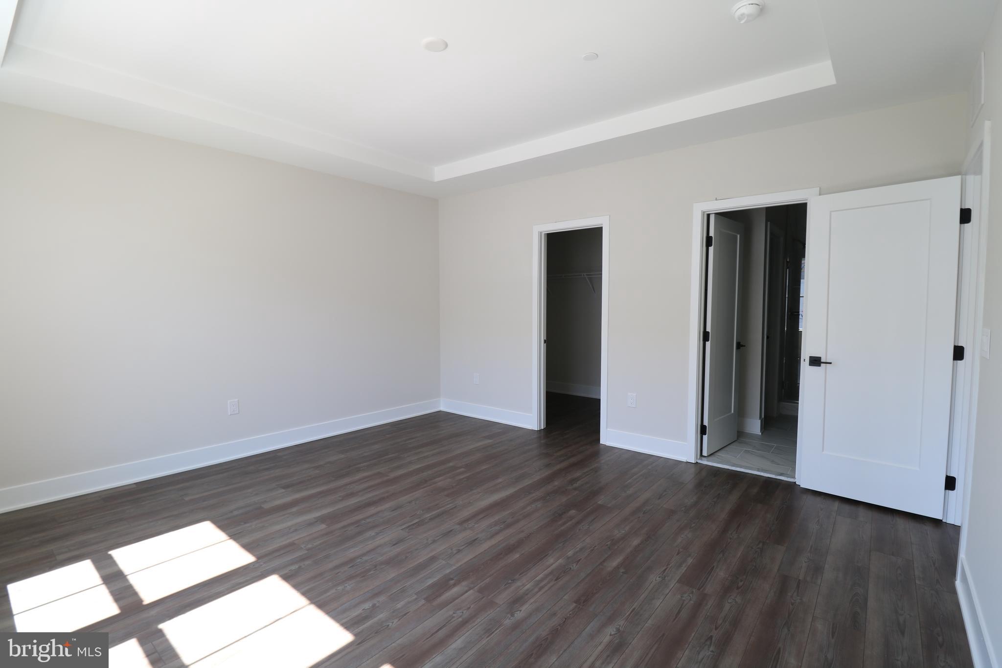 5105 Donatello Drive, Unit 541 Princeton, NJ 08540 - Photo 28 of 36 an empty room with wooden floor and windows