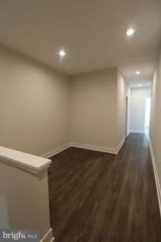 a view of hallway with wooden floor