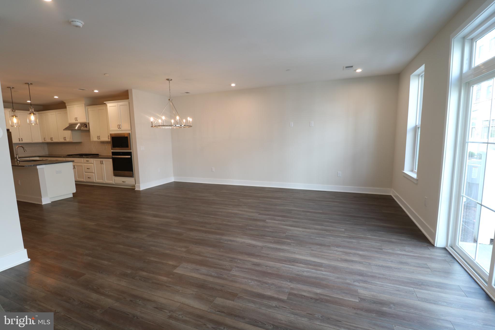 5105 Donatello Drive, Unit 541 Princeton, NJ 08540 - Photo 5 of 36 an empty room with wooden floor and outdoor view