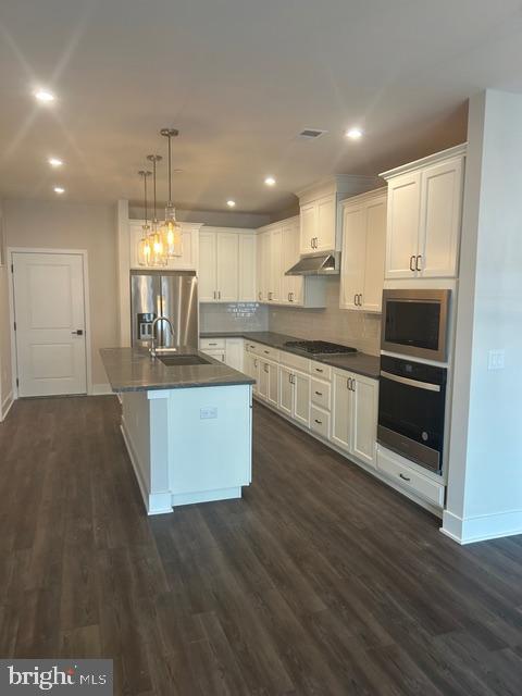 5105 Donatello Drive, Unit 541 Princeton, NJ 08540 - Photo 8 of 36 a kitchen with kitchen island granite countertop a stove top oven a sink and a counter top space