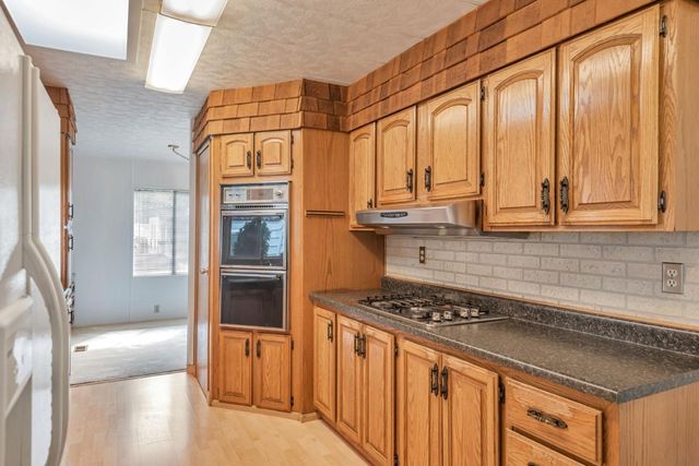 a kitchen with stainless steel appliances a stove and a refrigerator